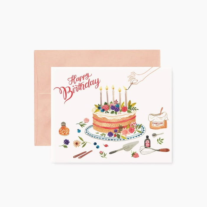 Birthday card with a cake illustration and 'Happy Birthday' text on a white background.