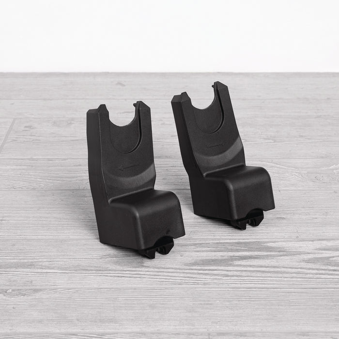 A pair of black car seat adapters designed for use with strollers.