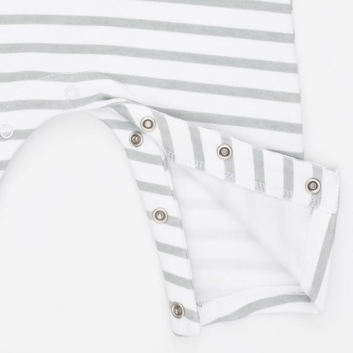 Close-up of a white and light gray striped baby garment with a folded sleeve or cuff showing metal snap buttons on a white background.
