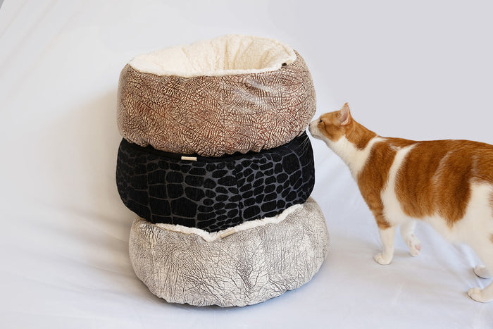 P.L.A.Y. Feline Frenzy Donut Cuddler Bed Group tower stack with ginger cat sniffing them