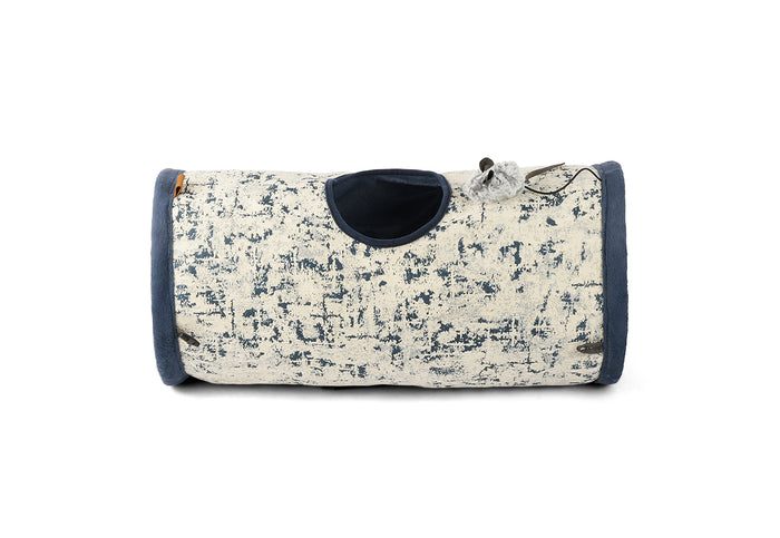 Feline Frenzy Purr & Pounce Cat Tunnel in Navy Blue Celestial print shown - side view - with dangling mouse toy sitting on top of it beside the peephole on a white background.