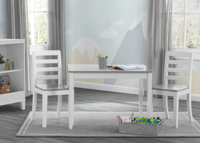 White children's table and chairs set in a room with toys and books.