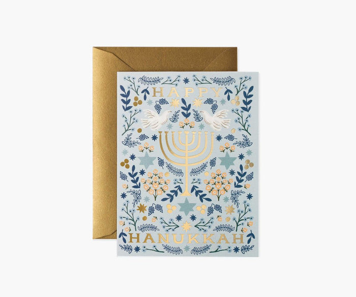 Hanukkah card with Menorah design and gold envelope on white background