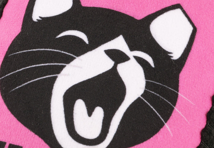 A close-up of the Jackson Galaxy x Feline Frenzy Stomp Box Kicker toy zooming in on the black cat face graphic with white details on a bright pink background.