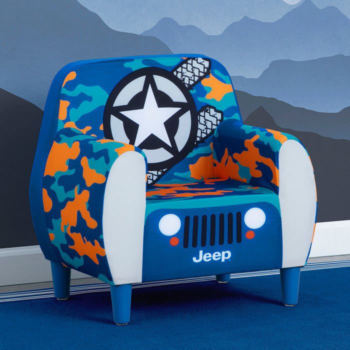Children's chair designed like a Jeep with camouflage pattern and star emblem against a mountain backdrop.