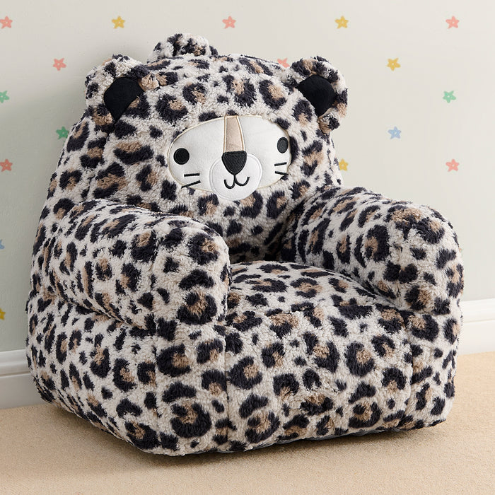 Leopard print children's chair with a face design on a light-colored floor and wall.