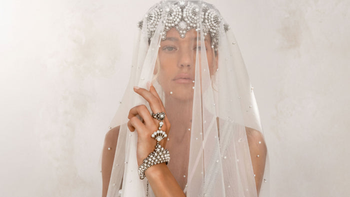 Woman wearing Eingana Crowm and veil with Mata Hari Jewlery by Object & Dawn on a plain background
