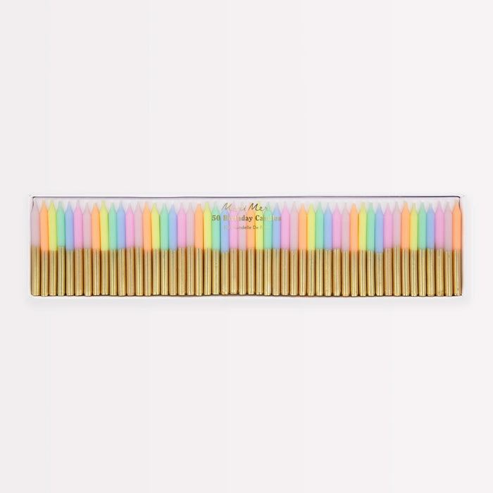 A set of 24 pastel-colored taper candles in a clear plastic case with gold metal wicks, shown against a plain white background.