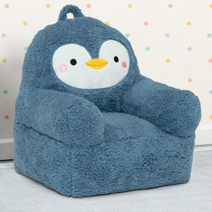 Blue penguin-shaped bean bag chair on a light gray floor with a star-patterned wall in the background.