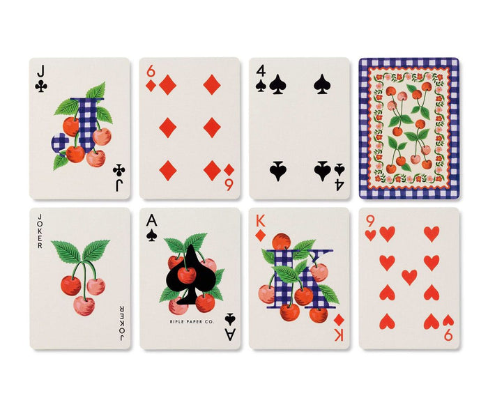 Set of playing cards with cherry-themed artwork on a white background