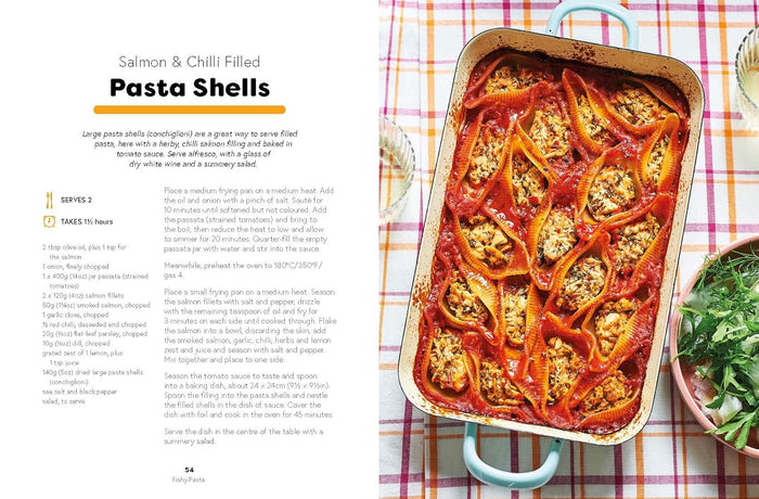 Pasta shells with salmon and chili in a baking dish on a checkered tablecloth