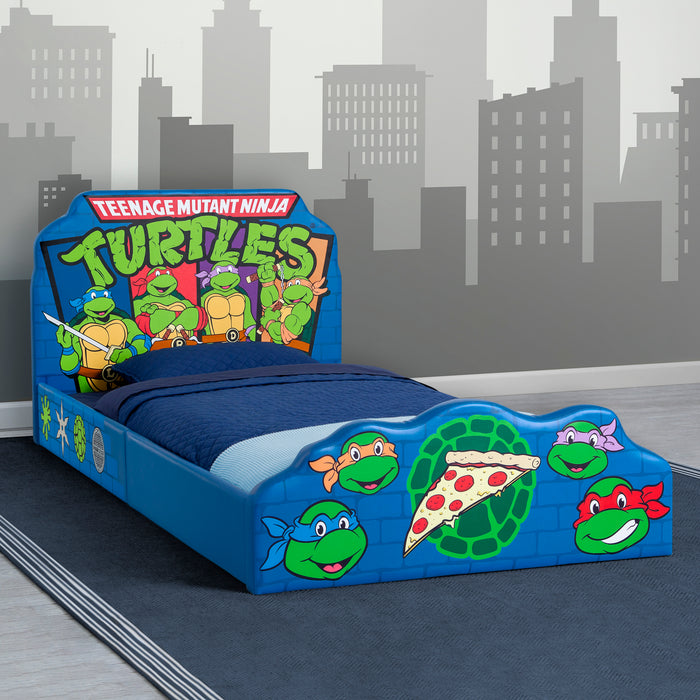 Children's bed with Teenage Mutant Ninja Turtles design against a cityscape background
