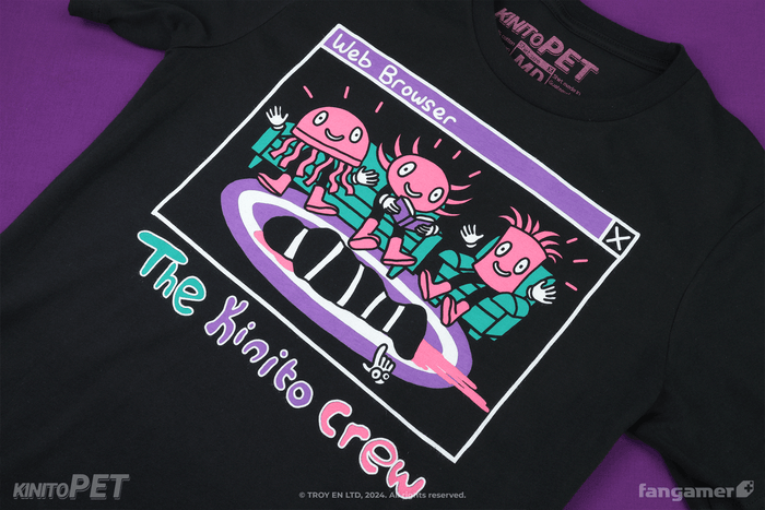 A black shirt with a cartoon representation of a computer window (titled Web Browser) showing The Kinito Crew in a living room environment with pink, green, and purple print colors. Something appears to be bleeding on the rug. "The Kinito Crew" is written in a naive, bubbly style.